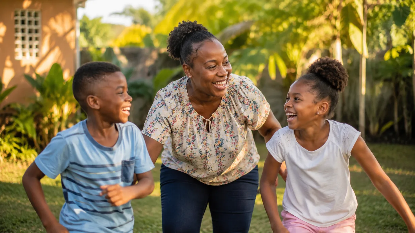 A caregiver laughing outdoors with two happy school-age children in a sunny garden
